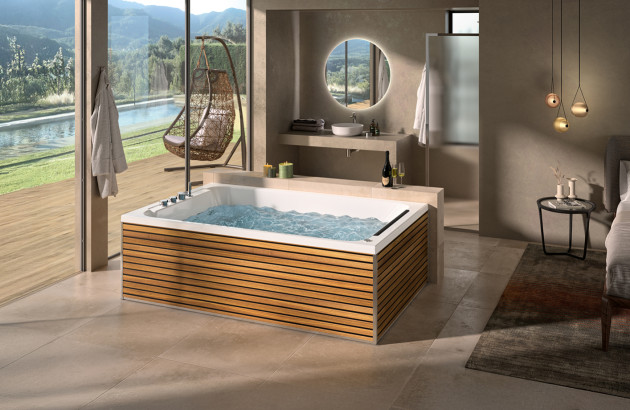 Grande salle de bains ouverte sur l'extérieur avec un spa 2 personnes au centre