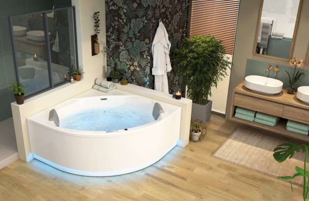 Baignoire balnéo d’angle dans une salle de bains végétale et contemporaine.
