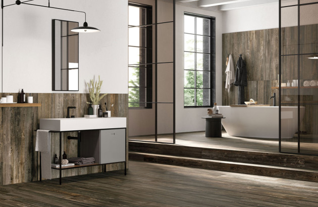 salle de bains design avec carrelage effet bois foncé et baignoire îlot blanche moderne