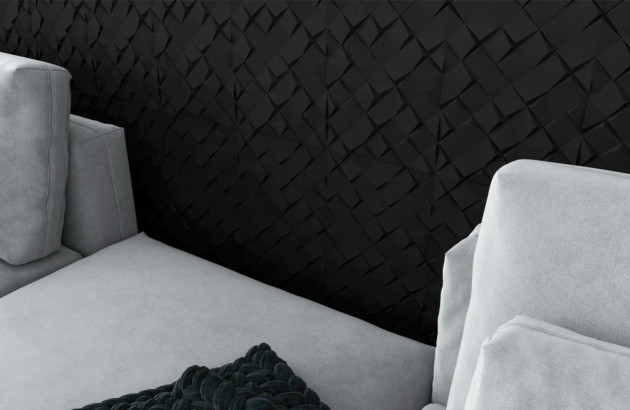 Carrelage mural noir texturé en relief, utilisé en crédence ou mur décoratif de cuisine contemporaine, illustrant une tendance durable et sophistiquée pour 2026.