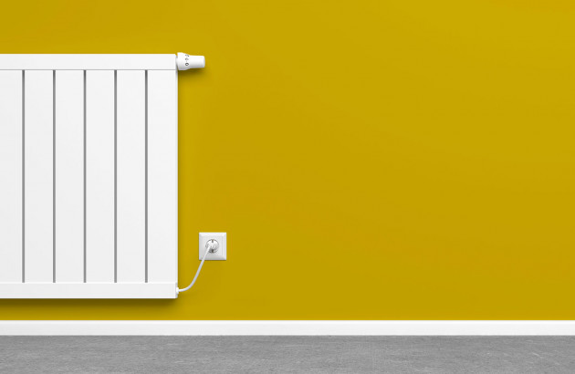 Radiateur électrique blanc sur mur jaune