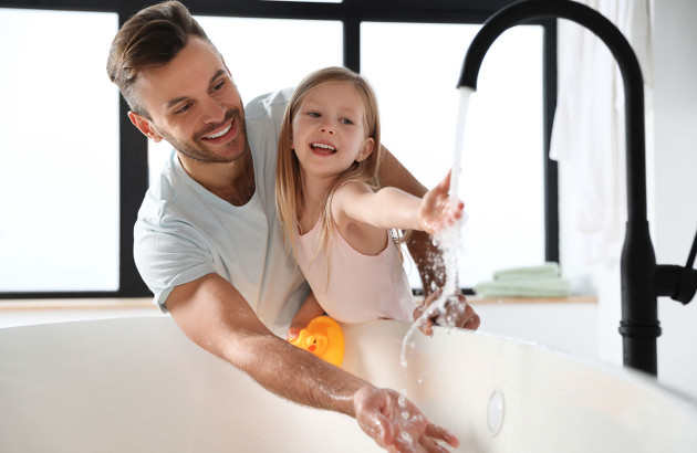 Famille dans une salle de bain qui fait couler de l'eau