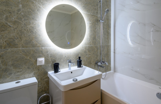 Salle de bains de 4 m² avec meuble, miroir lumineux et baignoire compacte