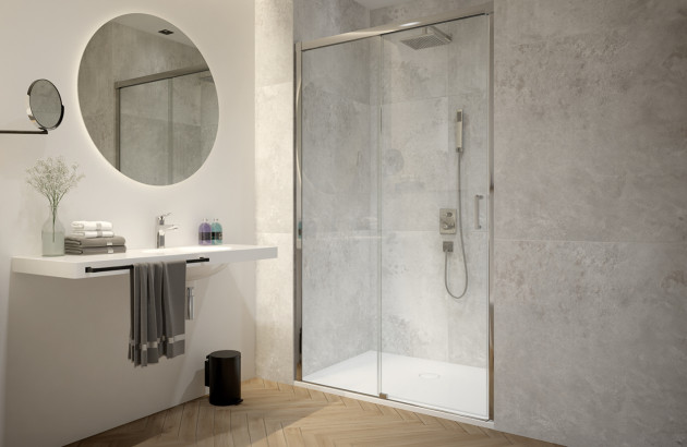 Salle de bains lumineuse avec douche vitrée, vasque suspendue et revêtement effet béton.