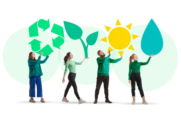 Personnes vêtues de vert qui tiennent des symboles écologiques