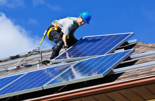 Professionnel qui installe un panneau solaire