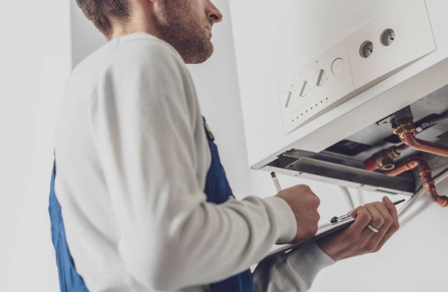 Professionnel qui installe une chaudiere à gaz