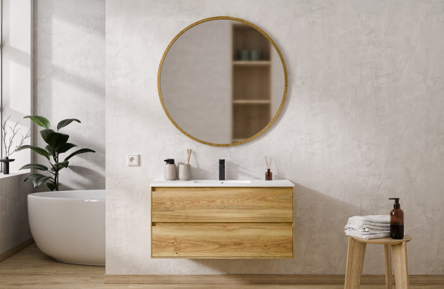 Meuble vasque suspendu effet bois avec deux grands tiroirs et miroir rond dans une salle de bains lumineuse.