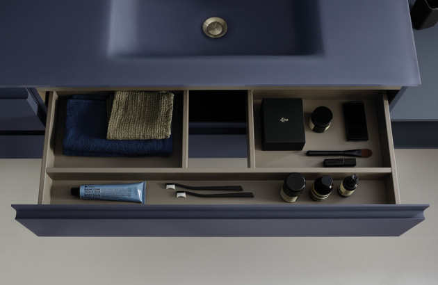 Tiroir de meuble sous vasque avec compartiments de rangement pour accessoires de toilette.