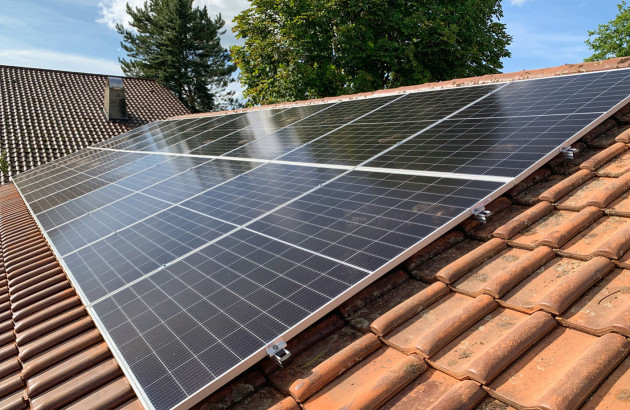 Panneaux solaires photovoltaïques installés en surimposition sur une toiture en tuiles.