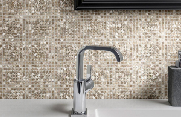 Mur derrière un robinet recouvert de carreaux de mosaïque