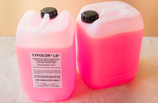 Deux bidons de fluide caloporteurs remplis de liquide de couleur rose