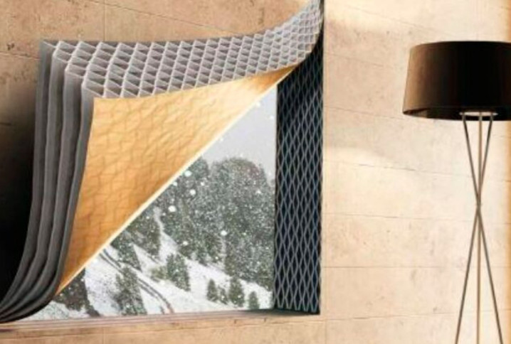 fenêtre avec des couches de matériaux isolants superposées et une vue sur un paysage enneigé
