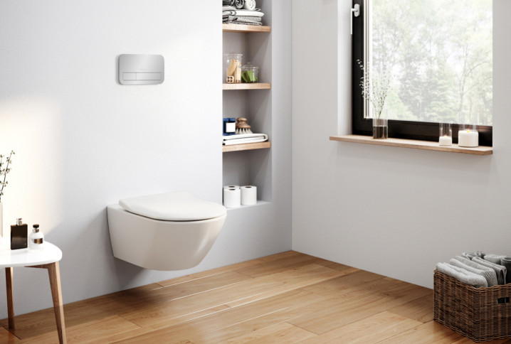 WC suspendu sans bride fixé au mur dans une salle de bains moderne, avec bâti-support encastré, sol en bois clair, niche de rangement intégrée et design épuré facilitant le nettoyage du sol.