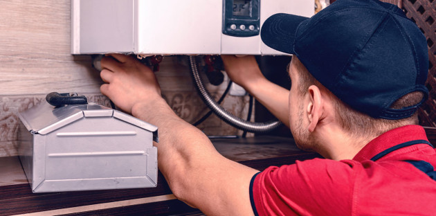 Technicien effectuant l'entretien d'un chauffe-eau