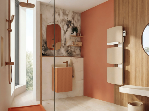 une salle de bain au design minimaliste doux combinant des tons terre cuite et bois clair, avec une douche à l'italienne, un lave-mains façade cannelée et un sèche-serviette moderne aux formes galbées.