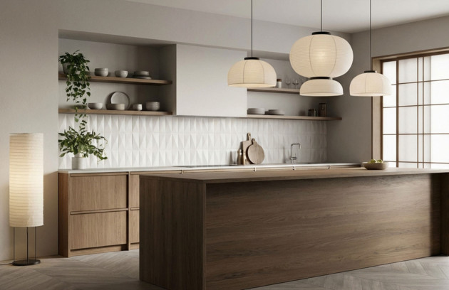 Cuisine contemporaine avec faïence murale blanche en relief géométrique, plan de travail et meubles en bois, illustrant le choix de la faïence décorative pour une crédence moderne.