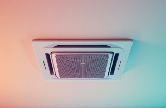 Climatisation gainable encastrée au plafond, vue en contre-plongée, éclairage coloré en ambiance.